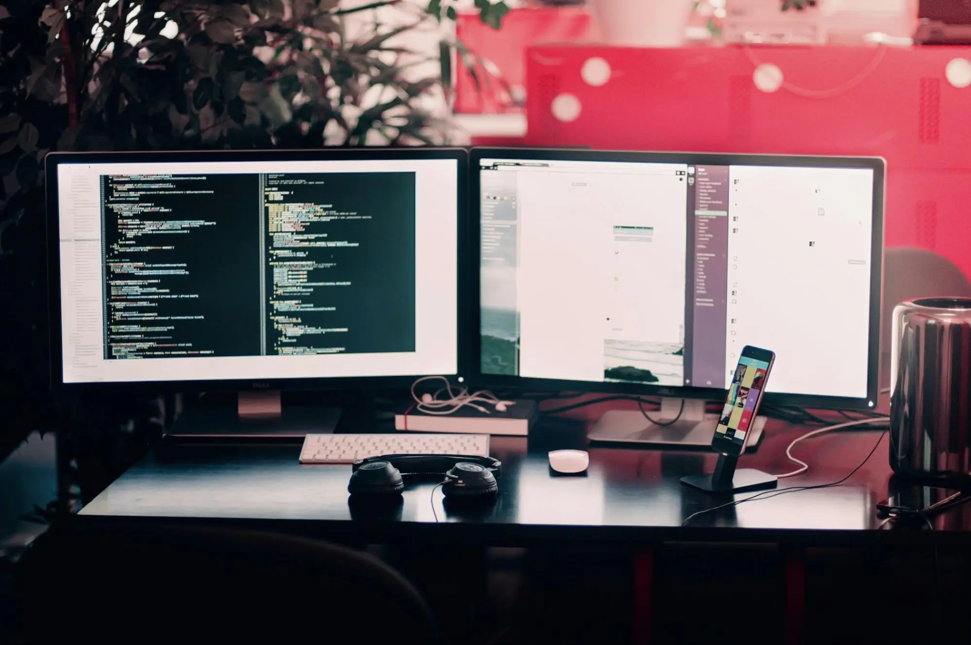 image of two desktop computers and one mobile phone set up on desk for a web developer, code on screen